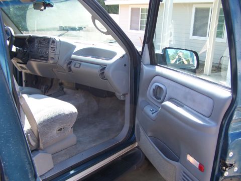 1995 Chevrolet Tahoe - View from the passenger side into the driver's side of a teal SUV, focusing on the interior details.