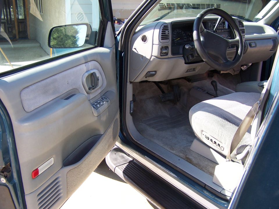 Interior of a 1995 Chevrolet Tahoe showing dashboard, steering wheel, and driver's seat