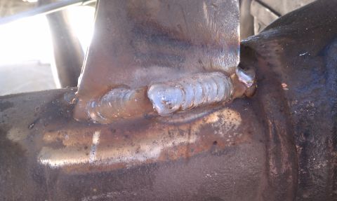 1990 Ford Bronco - A close-up view of a welded metal part, showing signs of wear and tear.
