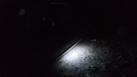 2000 Mercury Grand Marquis - Illuminated ground with debris. The image is very dark overall.
