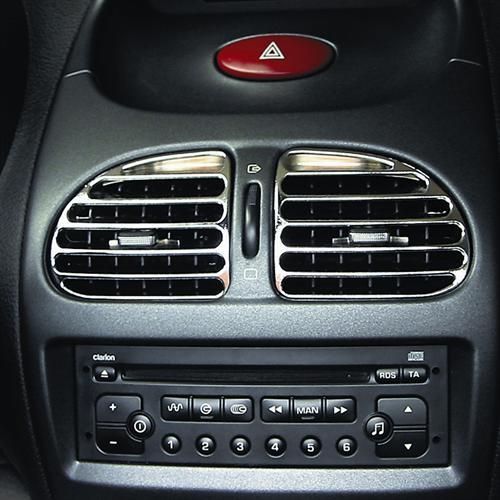 Car interior with chrome-trimmed air vents above a Clarion stereo. Hazard light button is visible