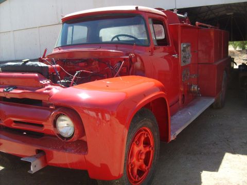 1986 Ford Bronco - A red fire truck sits outdoors with its hood open, revealing the engine bay.