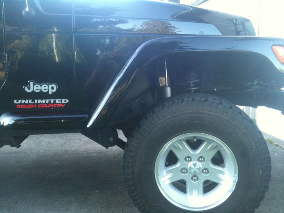 Close-up of black Jeep Wrangler rear fender with Unlimited Rough Country decals
