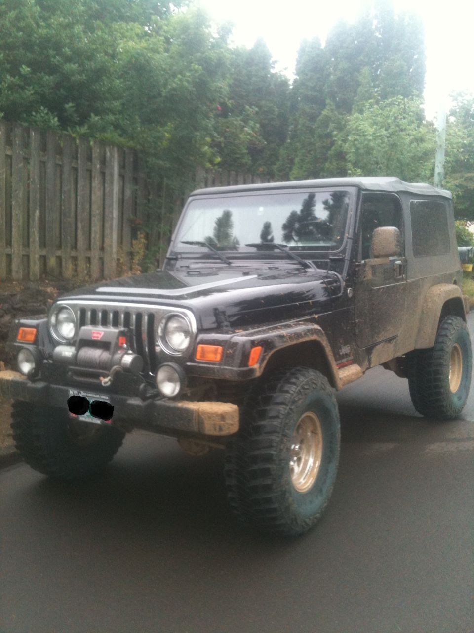 Black Jeep Wrangler with winch and off-road tires