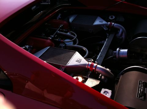 2010 Ford Falcon - The engine bay of a red vehicle is visible, twin intercoolers and associated piping.