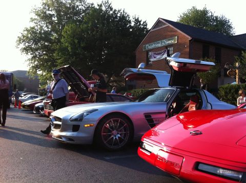 2010 Ford Falcon - A silver gullwing car is displayed with its doors open at an outdoor car show.