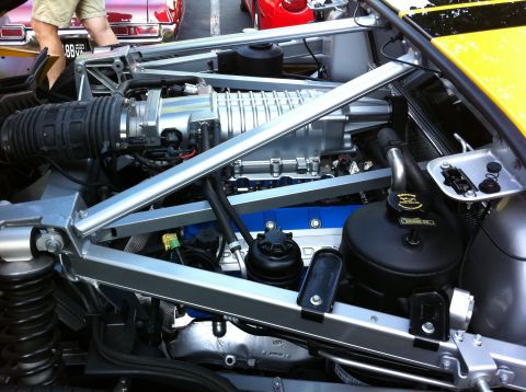 2010 Ford Falcon - Close-up of a V8 engine bay a large supercharger and custom blue valve covers.