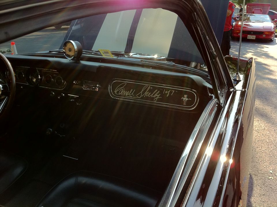 Shelby 1967 badge on car interior dashboard