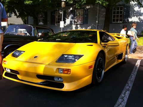2010 Ford Falcon - A bright yellow sports car is parked on asphalt, with another vehicle partially visible to its left.