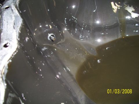 1995 Ford Probe - Undercarriage detail with fluid accumulation, dated 01/03/2008.