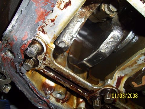 1995 Ford Probe - Close-up of an engine block's internal components, revealing wear and oil accumulation.
