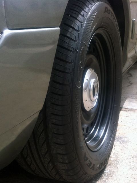 2001 Mercury Grand Marquis - A close-up shot focuses on the rear wheel and part of the fender of a vehicle.