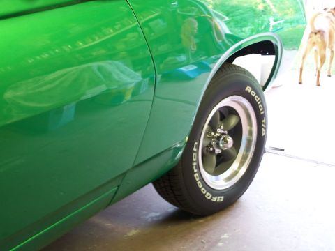 1971 Ford Ranchero - Close-up of the side of a green 1971 Ford Ranchero, showing the fender and wheel.
