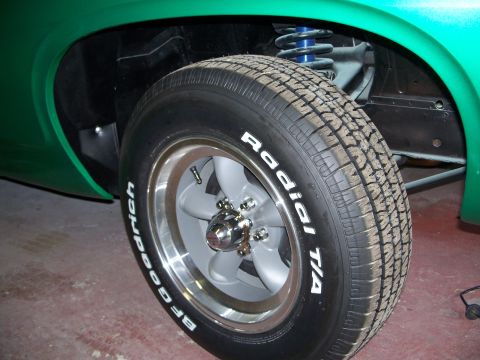 1971 Ford Ranchero - A close-up view of a vehicle's wheel and suspension components, showing the tire and part of the fender.