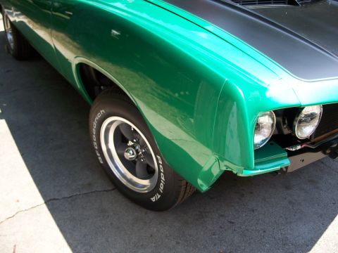 1971 Ford Ranchero - Front fender and headlight detail of a green 1971 Ford Ranchero.