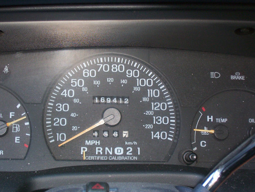 Ford instrument cluster with 140 mph speedometer and 169412-mile odometer reading
