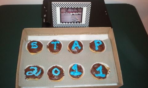 1998 Ford Crown Victoria - A box of cupcakes spelling out 'STAP 2011' sits next to a framed picture of a car at Atlanta.