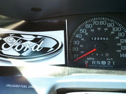 1998 Ford Crown Victoria - Dashboard view a Ford logo sticker and the vehicle's speedometer and odometer.