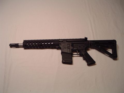 1995 Mercury Grand Marquis - A black assault rifle is shown against a plain background.