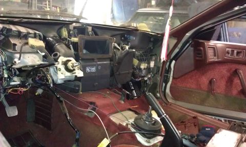 1987 Mazda RX-7 - Disassembled interior of a 1987 Mazda RX-7, revealing the dashboard and wiring harness.