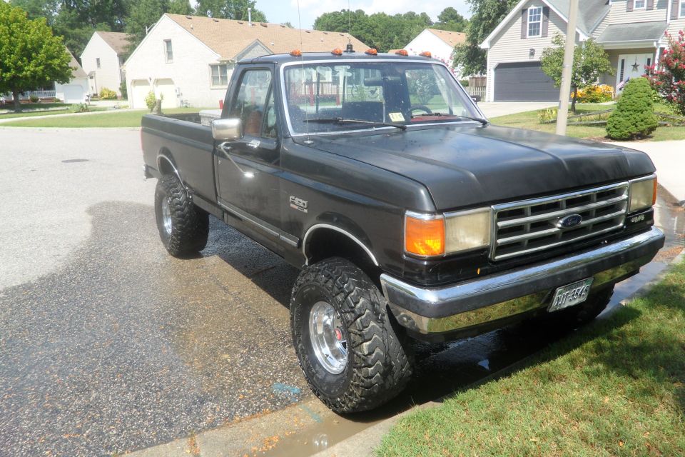 Black 1988 Ford F-150 with lifted suspension and large tires
