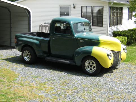 1992 Ford Mustang - Pickup truck with a two-tone paint job and custom wheels sits in a driveway.