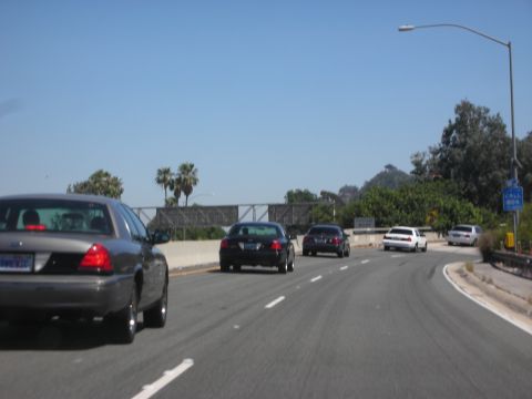 2004 Ford Crown Victoria - Driving on the highway behind a gray 2004 Ford Crown Victoria.
