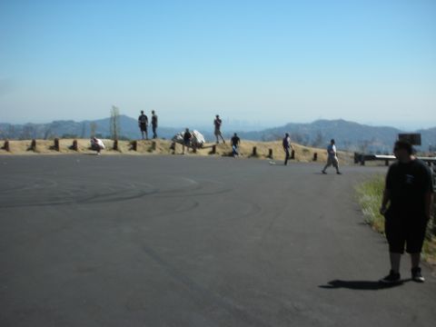 2004 Ford Crown Victoria - A group of people are gathered on a hill with a view of a distant city.