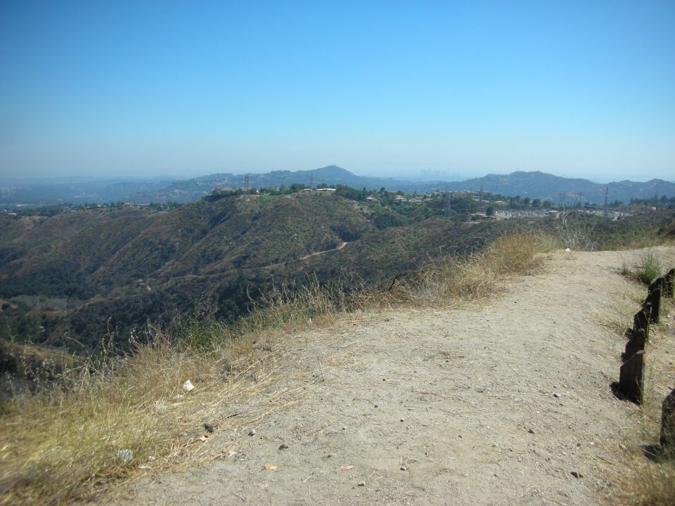 View of hills and distant city under a clear blue sky