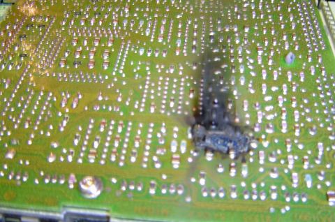 1993 Ford Bronco - Circuit board shows significant burn damage in one section.