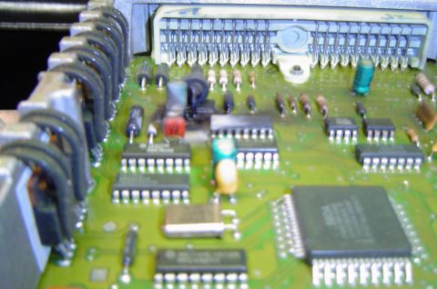 1993 Ford Bronco - This is a close-up view of an electronic control unit's circuit board, showing its intricate components and wiring.