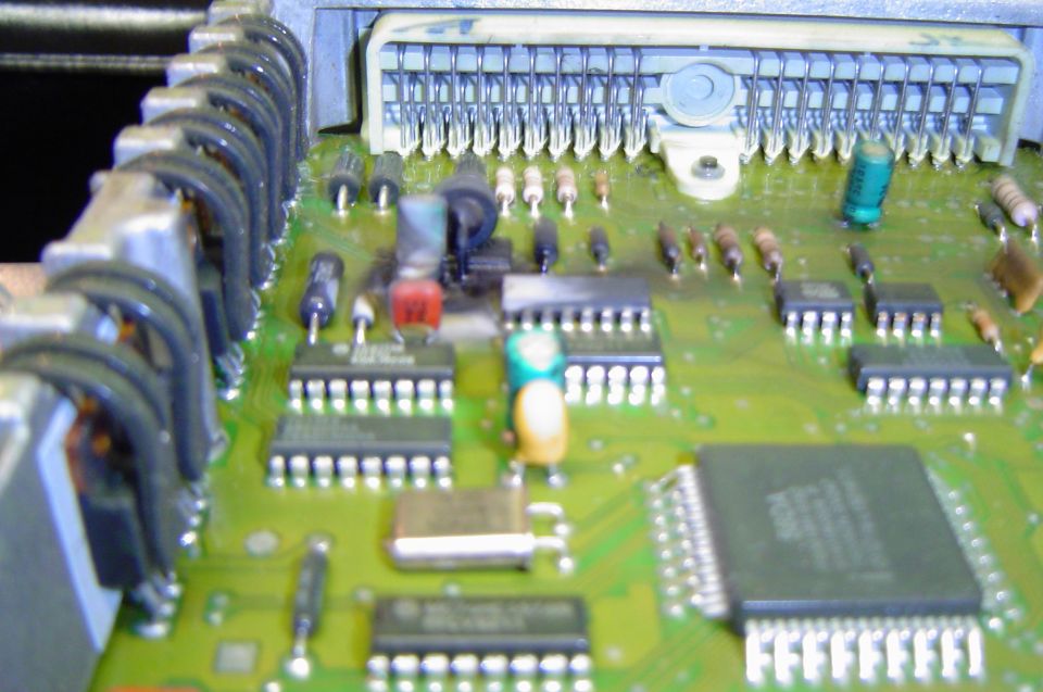 Green ECU circuit board with processor chip, capacitors and multi-pin connector