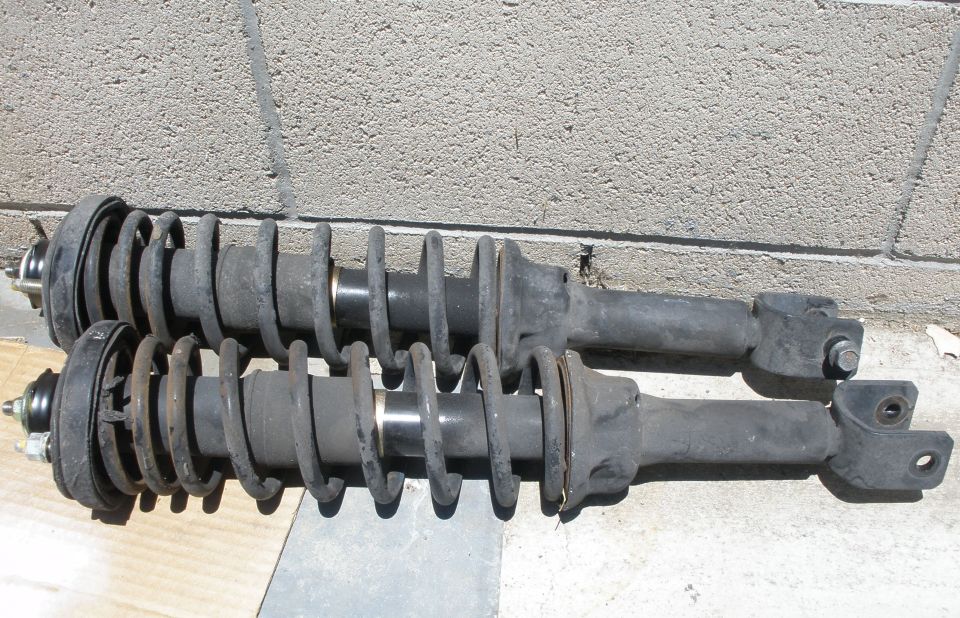 Pair of front shock absorbers with coil springs, one slightly above the other