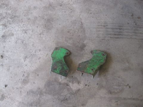 1995 Ford Ranger - Two green metal brackets are shown on a concrete surface.