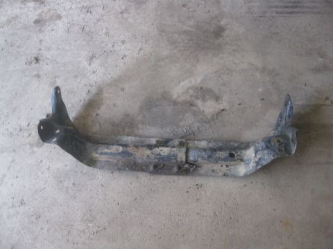 1995 Ford Ranger - A single, dirty metal automotive part is shown lying on a concrete surface. It appears to be a structural component.