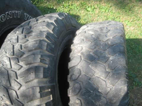 1995 Ford Ranger - Close-up view of two off-road tires with aggressive tread patterns resting on a grassy surface.