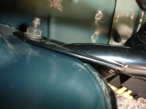 1995 Ford Taurus - A close-up view shows the mounting hardware for a strut tower brace, highlighting the connection point to the vehicle's chassis.