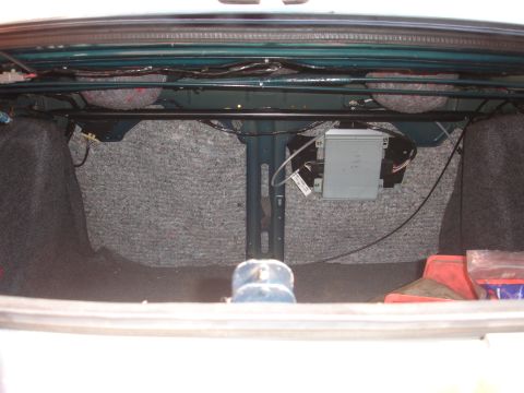 1995 Ford Taurus - The trunk interior shows carpeting, wiring, and an electronic control unit.