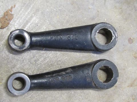 1995 Ford Bronco - Two power steering arms are shown, each stamped with 'PWR STG'.