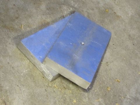 1995 Ford Bronco - Two metal plates are shown resting on a concrete surface, with one plate partially obscuring the other.