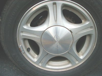 1997 Ford Taurus - This image shows a close-up of a Ford wheel, likely from a vehicle of that brand. The registry claims it is a 1997 Ford Taurus, but the ima…