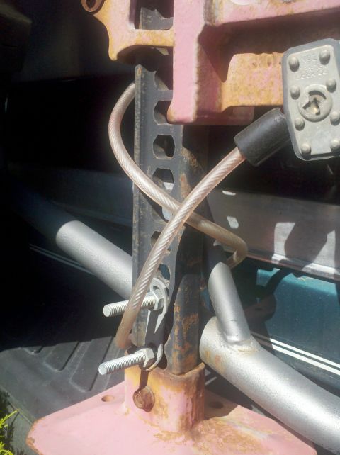 1996 Ford Bronco - A hi-lift jack is mounted and secured with a cable lock and bolts within the vehicle.