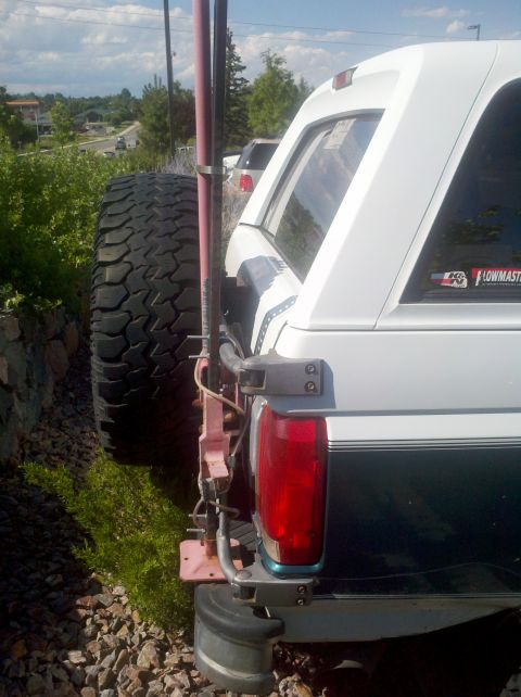1996 Ford Bronco - Rear view of a 1996 Ford Bronco showing a high lift jack attached to the spare tire carrier.