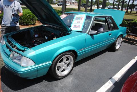 2007 Ford Mustang - A teal coupe, likely a Ford Mustang from the late 1980s, is displayed with its hood and trunk open.