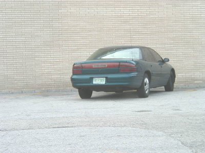 1997 Ford Taurus - Rear view of a green 1997 Ford Taurus parked outdoors.