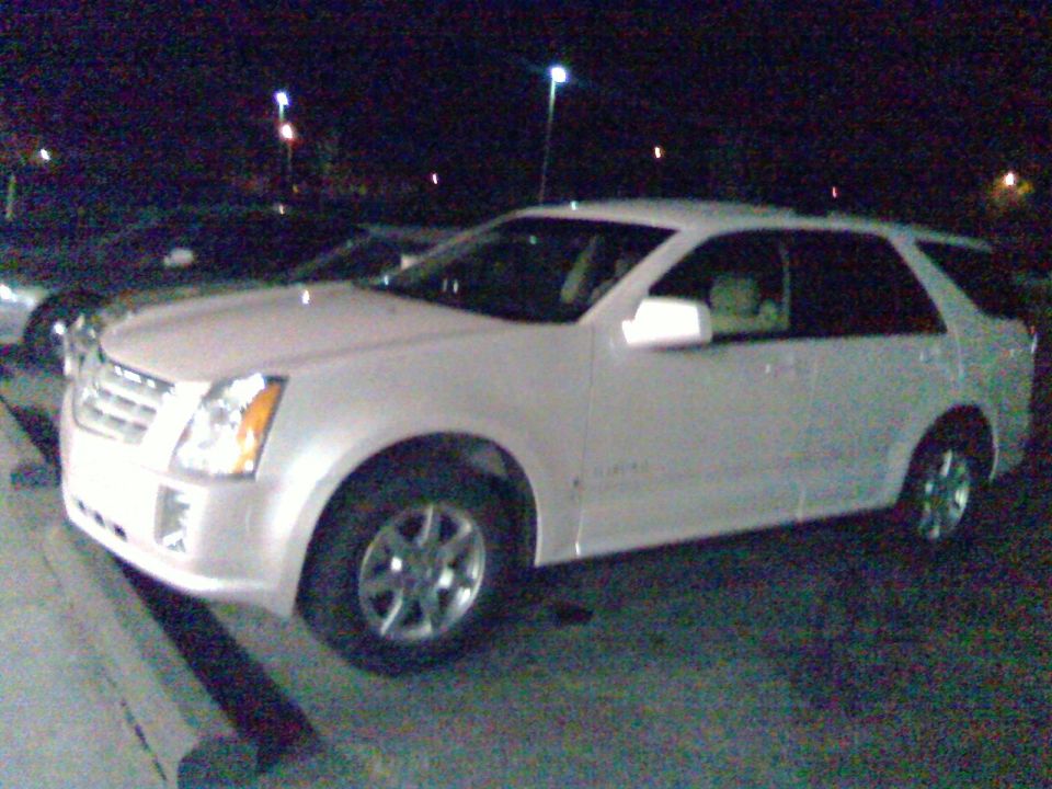White Cadillac SRX parked at night