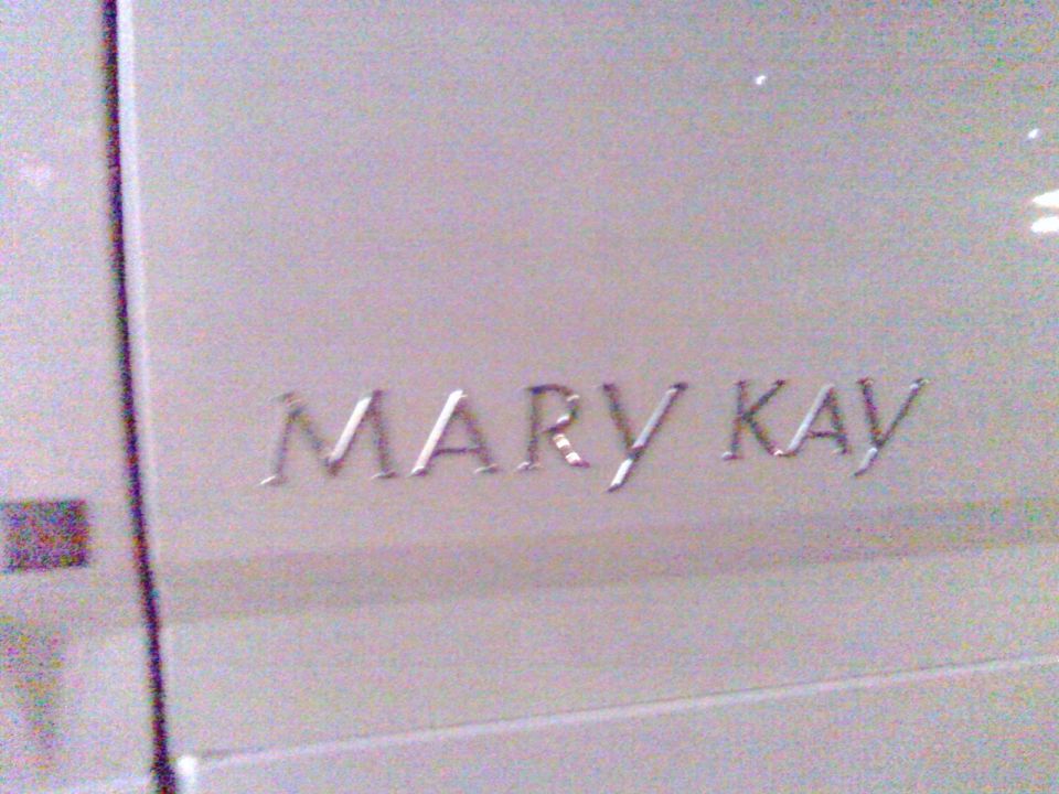 Embossed "MARY KAY" lettering on a light-colored surface