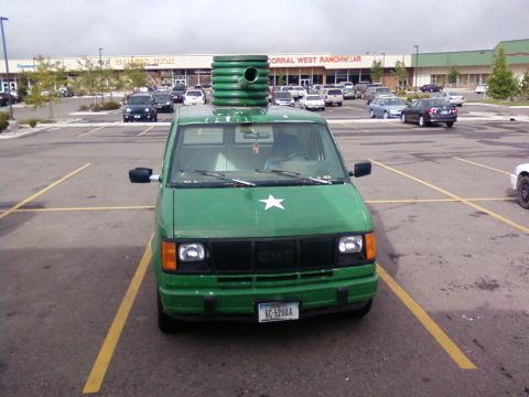2006 Ford E350 - Front view of a green GMC Safari van decorated military-style with a rooftop turret tube and white star, parked outside Corral West Ranchwe…