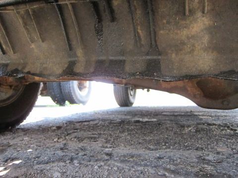 1991 Ford LTD Crown Victoria - The underside of a vehicle is visible, with a focus on the differential and a portion of a tire.