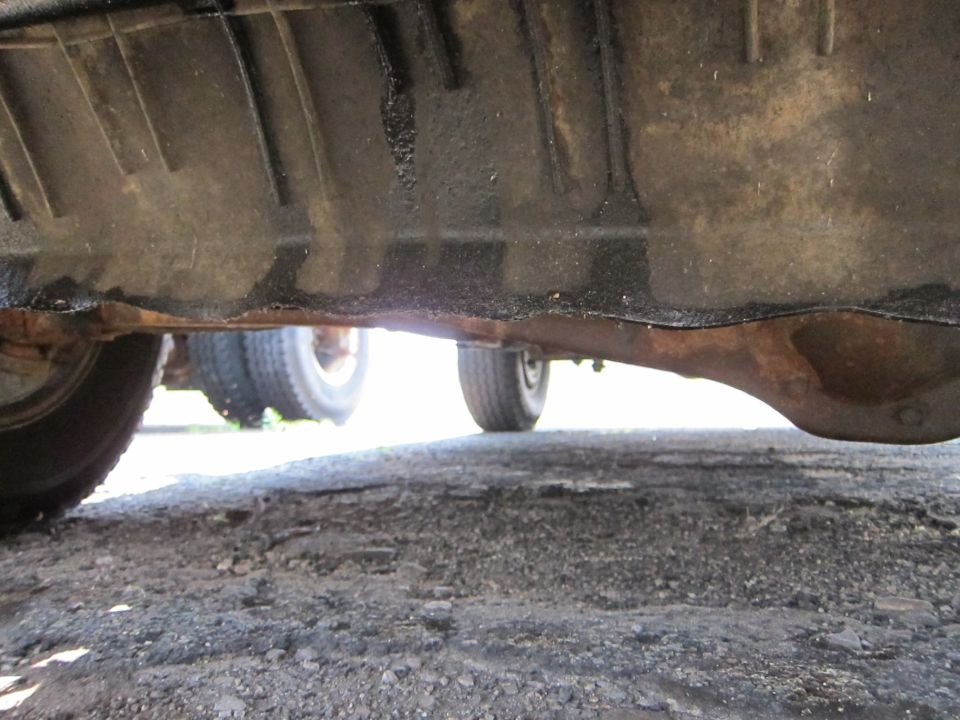 Underside of a vehicle showing the differential and part of a tire